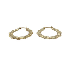 Load image into Gallery viewer, Bring texture and timeless style to your collection with these pre-owned 9ct yellow gold hoop earrings, designed in a twisted flat creole shape for added elegance.

Design: Each earring features a flat hoop with a subtle twist, creating a refined look that catches the light beautifully.
Material: Made from 9-carat yellow gold, the polished finish enhances the warm golden tone and shine.
Earring Detail: The creole style ensures secure wear while the twisted design adds a touch of modern sophistication.
