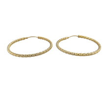 Load image into Gallery viewer, Bring bold texture and golden shine to your collection with these pre-owned 9ct yellow gold hoop earrings, styled in a large twisted design for standout elegance.

Design: Each earring features a wide hoop with a twisted finish, creating depth and sparkle as the light reflects off the curves.
Material: Made from 9-carat yellow gold, the polished surface enhances the warm tone and striking texture.
