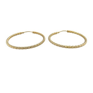 Bring bold texture and golden shine to your collection with these pre-owned 9ct yellow gold hoop earrings, styled in a large twisted design for standout elegance.

Design: Each earring features a wide hoop with a twisted finish, creating depth and sparkle as the light reflects off the curves.
Material: Made from 9-carat yellow gold, the polished surface enhances the warm tone and striking texture.