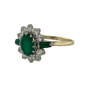 Bring vibrant colour and sparkling detail to your collection with this pre-owned 9ct yellow gold cluster ring, designed with an emerald-coloured centre stone framed by cubic zirconia and accented with green shoulder stones.

Design: The ring showcases an 8mm by 6mm oval green stone at the centre, surrounded by a halo of cubic zirconia, with rectangular green stones set into each shoulder for added depth and balance.