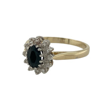 Load image into Gallery viewer, Bring classic elegance and refined sparkle to your collection with this pre-owned 9ct yellow gold cluster ring, featuring a sapphire centre stone framed by diamonds.

Design: The ring showcases a 6mm by 4mm oval sapphire at the centre, surrounded by diamonds with a total content of approximately 0.10ct, creating a timeless cluster style.
Material: Made from 9-carat yellow gold, the polished finish enhances the warm tone and contrasts beautifully with the deep blue sapphire and bright diamonds.
