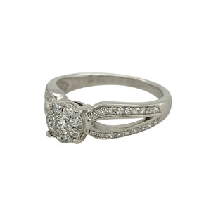 Bring refined sparkle and timeless elegance to your collection with this pre-owned 9ct white gold ring, styled with an illusion-set diamond cluster for maximum brilliance.

Design: The ring features a solitaire-style cluster of diamonds arranged in an illusion setting, giving the appearance of a larger central stone with a total diamond content of approximately 0.35ct.
