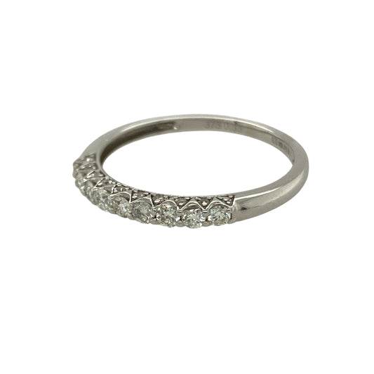 Bring subtle sparkle and timeless elegance to your collection with this pre-owned 9ct white gold band ring, styled with a row of diamonds across the front.

Design: The 2mm wide front of the band is set with diamonds totalling approximately 0.33ct, adding refined brilliance to the sleek design.
Material: Made from 9-carat white gold, the polished finish enhances the cool tone and complements the sparkle of the stones.
