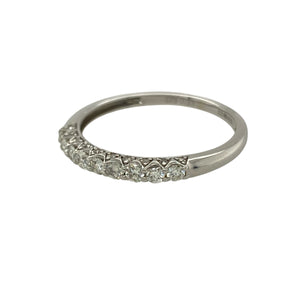Bring subtle sparkle and timeless elegance to your collection with this pre-owned 9ct white gold band ring, styled with a row of diamonds across the front.

Design: The 2mm wide front of the band is set with diamonds totalling approximately 0.33ct, adding refined brilliance to the sleek design.
Material: Made from 9-carat white gold, the polished finish enhances the cool tone and complements the sparkle of the stones.