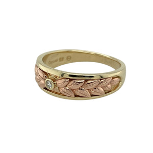 Celebrate elegance and heritage with this pre-owned 9ct yellow and rose gold Clogau Lilibet band ring, beautifully accented with sparkling diamonds for a refined and timeless look.

Design: The ring features a 7mm wide band with intricate detailing in yellow and rose gold, enhanced by diamond accents that add brilliance and sophistication.
Material: Made in 9-carat yellow and rose gold, the combination of warm tones offers depth and richness, perfectly complemented by the diamonds.
