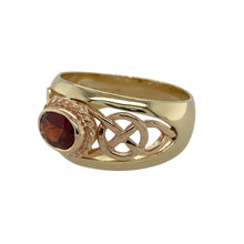 Load image into Gallery viewer, Embrace rich colour and heritage design with this pre-owned 9ct yellow and rose gold Clogau Celtic wide band ring, highlighted by a deep garnet stone for a bold and elegant presence.

Design: The ring showcases a 12mm wide Celtic-inspired band in yellow and rose gold, centred with a 5mm by 7mm oval garnet that adds warmth and striking contrast.
Material: Made in 9-carat yellow and rose gold, the polished finish enhances the intricate Celtic pattern while the garnet’s deep red hue brings timeless allure.
