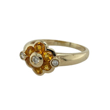 Load image into Gallery viewer, Bring warmth and sparkle to your collection with this pre-owned 9ct yellow gold citrine and diamond flower ring, a vibrant design full of timeless charm.

Design: The ring features a flower-shaped cluster with a golden citrine at the centre, accented by surrounding diamonds for a bright and elegant look.
Material: Made in 9-carat yellow gold, the polished finish enhances the warm tones of the citrine and the brilliance of the diamonds.
