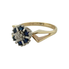 Load image into Gallery viewer, Add classic elegance to your collection with this pre-owned 9ct yellow gold sapphire and diamond cluster ring, a timeless piece with refined detail.

Design: The ring features a central diamond framed by a cluster of sapphires, each separated with touches of white gold to enhance contrast and definition.
Material: Made in 9-carat yellow gold with white gold accents, the polished finish complements the deep blue of the sapphires and the sparkle of the diamond.
