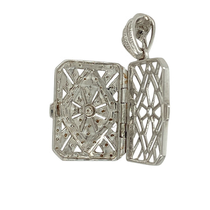 Combine elegance and sentiment with this pre-owned 18ct white gold diamond filigree locket, a timeless piece designed to hold cherished memories.

Design: The locket features a rectangular shape with intricate filigree detail, accented with sparkling diamonds for a refined and decorative finish.
Material: Made in 18-carat white gold, the polished finish enhances the brightness of the metal and the brilliance of the diamonds.