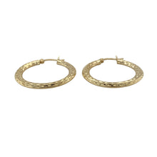 Load image into Gallery viewer, Bring classic style to your collection with these pre-owned 9ct yellow gold patterned hoop Creole earrings, a timeless design with subtle detail.

Design: Each earring features a traditional Creole hoop with a patterned finish, adding texture and elegance to the classic shape.
Material: Made in 9-carat yellow gold, the polished finish enhances the warm golden tone and highlights the decorative pattern.
