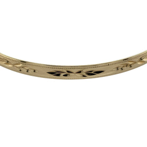 Add timeless elegance to your collection with this pre-owned 9ct yellow solid gold patterned bangle, a classic piece with refined detail.

Design: The bangle features a 5mm wide band with a decorative pattern, offering subtle texture and sophistication.
Material: Made in solid 9-carat yellow gold, the polished finish enhances the warm golden tone and the detailed design.
Bangle Detail: With an internal diameter of 6.7cm, this piece provides a comfortable fit while remaining durable for everyday wear.