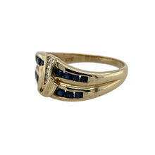 Load image into Gallery viewer, Add colour and brilliance to your collection with this pre-owned 9ct yellow gold sapphire and diamond swirl band ring, a bold design with timeless elegance.

Design: The ring features a 10mm high swirl-style band, set with two rows of sapphires and a central line of diamonds for a striking contrast.
Material: Made in 9-carat yellow gold, the polished finish provides a warm glow that enhances both the deep blue of the sapphires and the sparkle of the diamonds.

