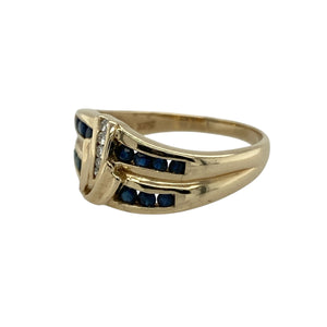 Add colour and brilliance to your collection with this pre-owned 9ct yellow gold sapphire and diamond swirl band ring, a bold design with timeless elegance.

Design: The ring features a 10mm high swirl-style band, set with two rows of sapphires and a central line of diamonds for a striking contrast.
Material: Made in 9-carat yellow gold, the polished finish provides a warm glow that enhances both the deep blue of the sapphires and the sparkle of the diamonds.