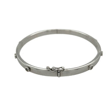Load image into Gallery viewer, Add refined sparkle to your collection with this pre-owned 9ct white gold diamond hinged bangle, a timeless design with elegant detail.

Design: The bangle measures 4mm wide with a 6cm diameter and is set with eight diamonds across the front for subtle brilliance.
Material: Made in 9-carat white gold, the polished finish enhances the sleek tone and highlights the sparkle of the diamonds.

