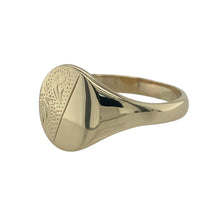 Load image into Gallery viewer, Bring bold detail and classic design to your collection with this pre-owned 9ct yellow gold oval patterned signet ring, offering a traditional style with a distinctive finish—perfect for everyday wear or as a statement accessory.

Design: The ring features an oval-shaped front measuring 14mm high, detailed with a patterned surface that adds texture and individuality.
Material: Made from 9-carat yellow gold, the polished band enhances the decorative front and provides a warm, refined tone.
