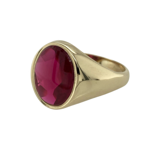 Bring bold colour and classic design to your collection with this pre-owned 9ct gold and red stone oval signet ring, a striking piece that blends traditional style with standout presence.

Design: The ring features a large oval red stone measuring 14mm by 11mm, creating a vivid centrepiece with smooth and polished appeal.
Material: Made from 9-carat gold, the warm tone of the band enhances the rich colour of the stone for a refined and eye-catching finish.