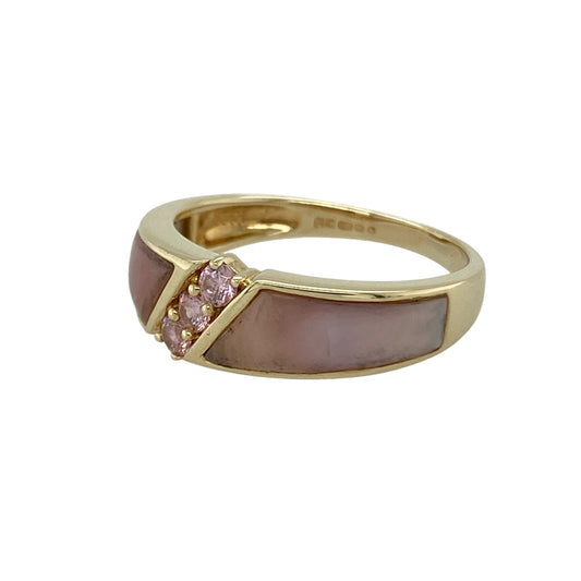 Bring soft colour and refined elegance to your collection with this pre-owned 9ct yellow gold pink sapphire and pink mother of pearl band ring, a graceful piece perfect for everyday style or special occasions.

Design: The ring features a 7mm wide band set with panels of pink mother of pearl, accented by sparkling pink sapphires for added vibrancy and charm.