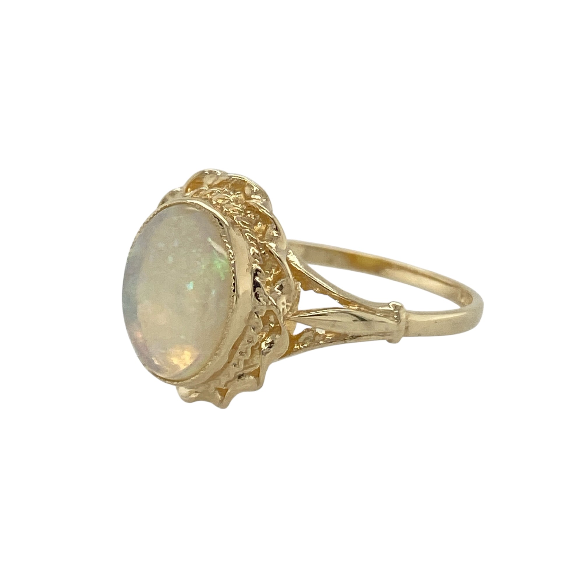 Bring soft colour and classic elegance to your collection with this pre-owned 9ct yellow gold opalique oval ring, a refined design enhanced by a traditional rope-style surround.

Design: The ring features an oval opalique stone measuring 10mm by 8mm, framed with a rope-style border that adds texture and timeless detail.
Material: Made from 9-carat yellow gold, the polished finish complements the iridescent tones of the opalique while providing a warm glow.