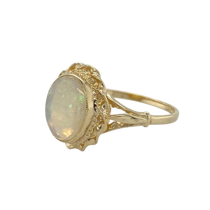 Bring soft colour and classic elegance to your collection with this pre-owned 9ct yellow gold opalique oval ring, a refined design enhanced by a traditional rope-style surround.

Design: The ring features an oval opalique stone measuring 10mm by 8mm, framed with a rope-style border that adds texture and timeless detail.
Material: Made from 9-carat yellow gold, the polished finish complements the iridescent tones of the opalique while providing a warm glow.