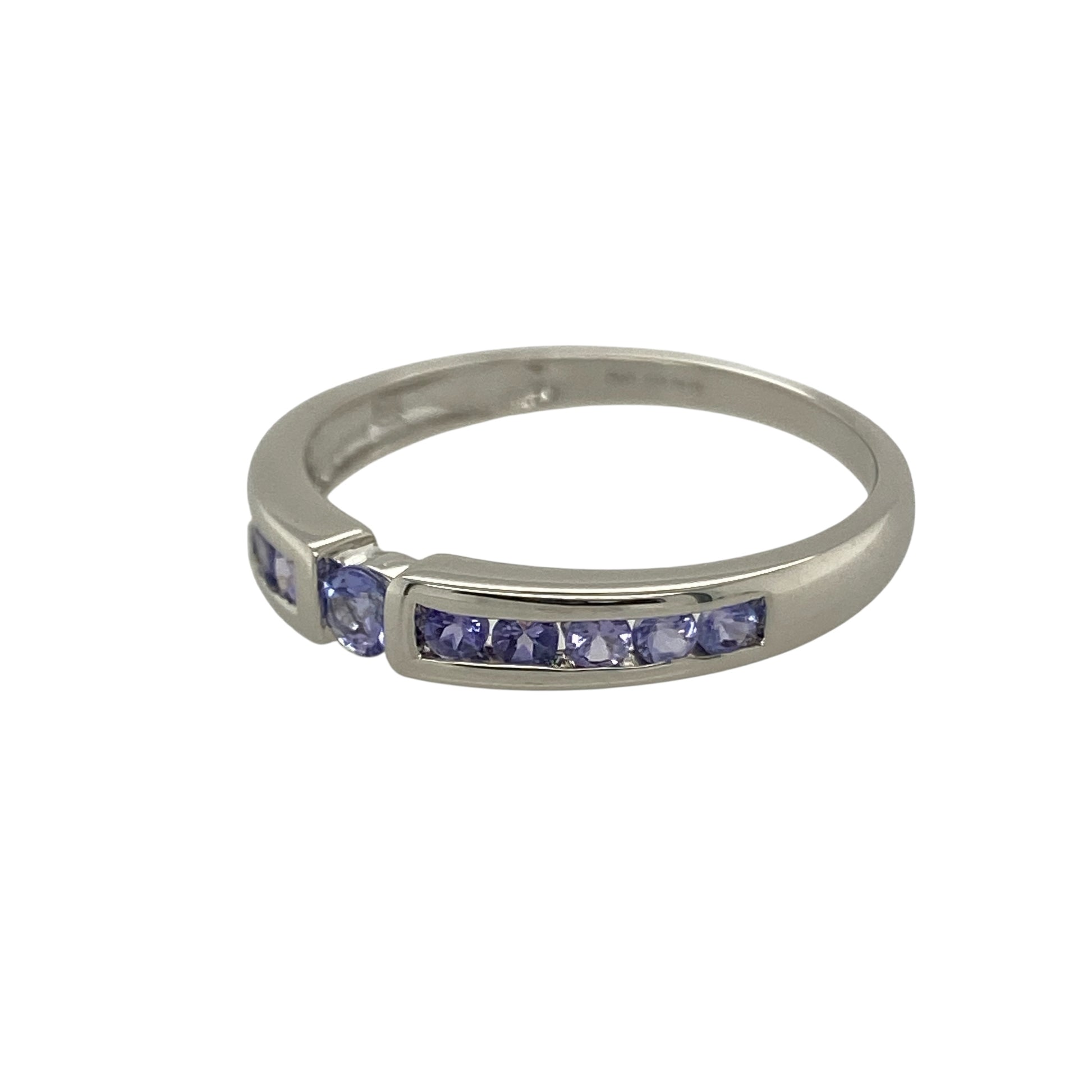 Bring subtle colour and refined elegance to your collection with this pre-owned 9ct white gold band ring, accented with a lavender-toned blue/purple stone for a graceful finish.

Design: The ring features a slim band accented with a single lavender-coloured stone, displaying delicate blue and purple hues for a soft and distinctive look.
Material: Made from 9-carat white gold, the polished finish enhances the cool tones of the band while complementing the gentle colour of the stone.