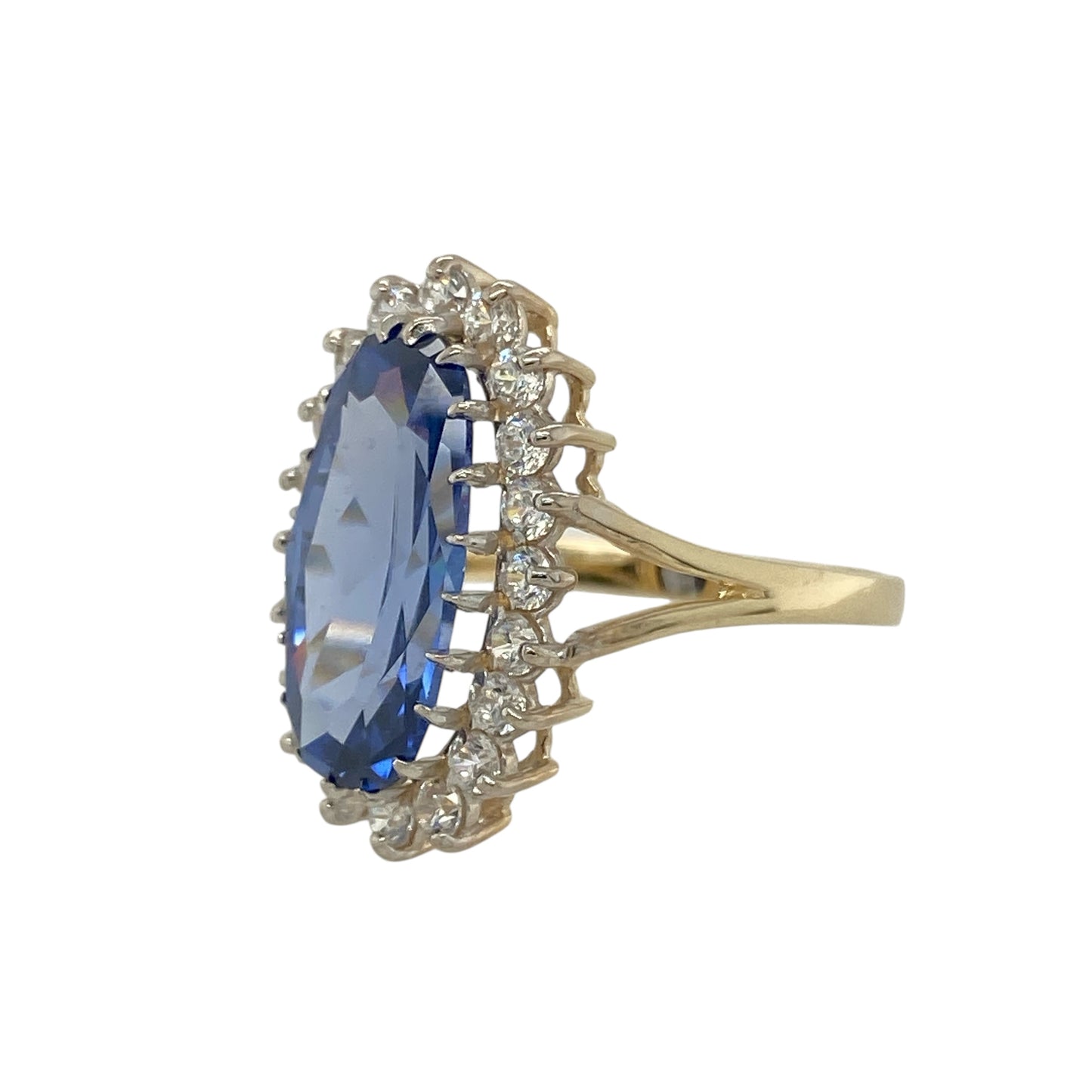 Bring vibrant sparkle and elegant colour to your collection with this pre-owned 9ct yellow gold cluster ring, featuring a striking light blue stone framed with cubic zirconia for timeless appeal.

Design: The ring showcases a 15mm by 7mm oval-cut light blue stone at the centre, surrounded by a cluster of cubic zirconia stones that add brilliance and contrast.
Material: Made from 9-carat yellow gold, the polished finish enhances the sparkle of the stones while providing a warm, refined tone.