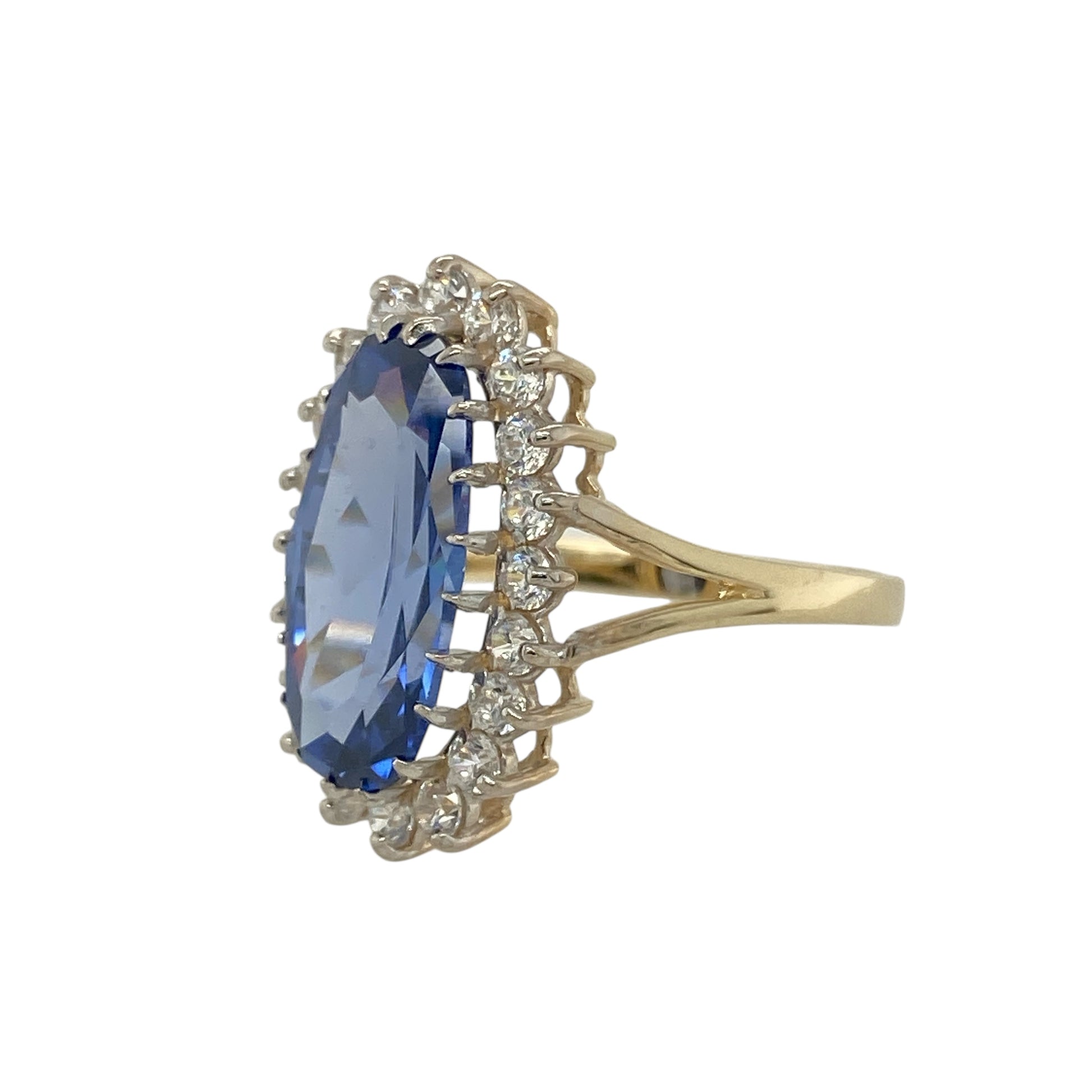 Bring vibrant sparkle and elegant colour to your collection with this pre-owned 9ct yellow gold cluster ring, featuring a striking light blue stone framed with cubic zirconia for timeless appeal.

Design: The ring showcases a 15mm by 7mm oval-cut light blue stone at the centre, surrounded by a cluster of cubic zirconia stones that add brilliance and contrast.
Material: Made from 9-carat yellow gold, the polished finish enhances the sparkle of the stones while providing a warm, refined tone.