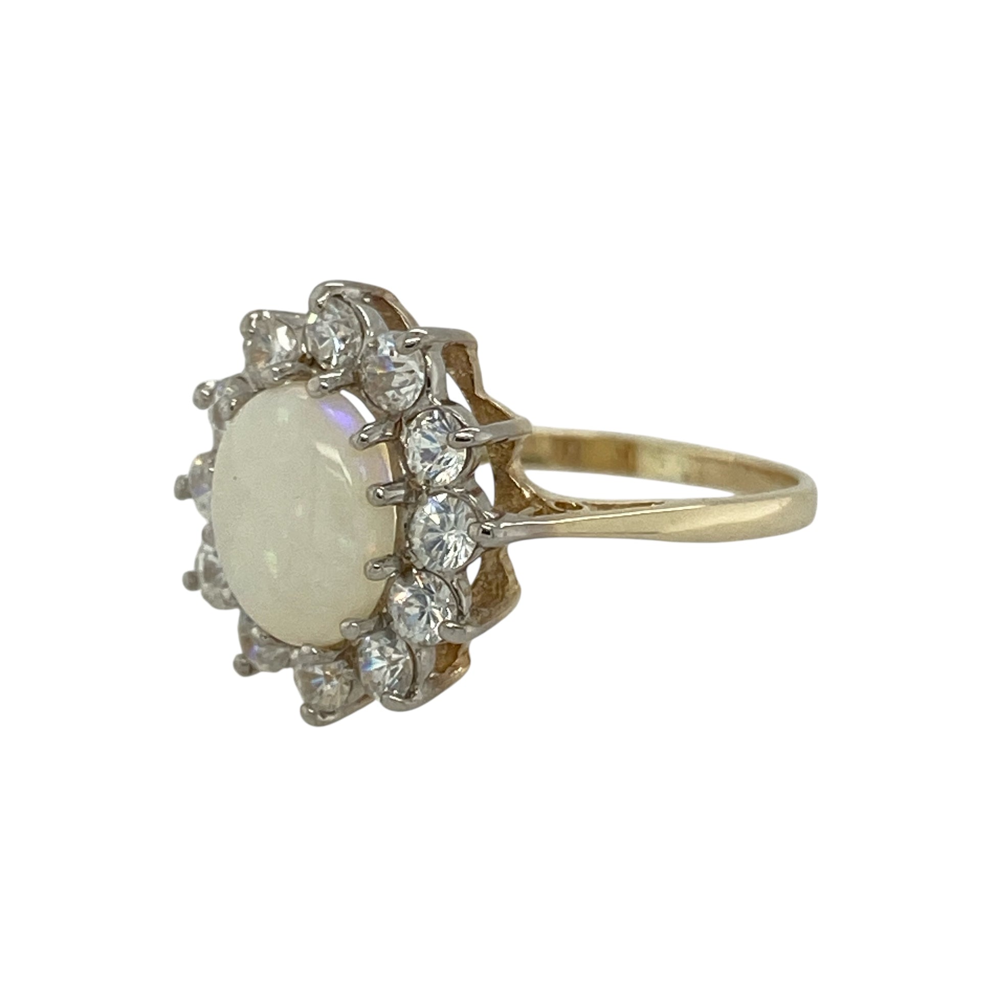 Bring shimmering colour and classic sparkle to your collection with this pre-owned 9ct yellow gold opalique and cubic zirconia cluster ring, a timeless design with elegant detail.

Design: The ring features an 8mm by 6mm oval opalique stone at the centre, surrounded by a cluster of cubic zirconia stones that enhance its iridescent tones with added brilliance.
Material: Made from 9-carat yellow gold, the polished finish complements the play of colour in the opalique while adding warmth and refinement.