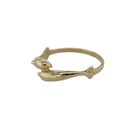 Bring playful charm and symbolic meaning to your collection with this pre-owned 9ct yellow gold double dolphin wrap-around ring, a light and distinctive design with timeless appeal.

Design: The ring features two dolphins wrapping around the band, with the front measuring 5mm wide, creating a lively and characterful look.
Material: Made from 9-carat yellow gold, the polished finish enhances the smooth detailing of the dolphins while adding a warm glow.
