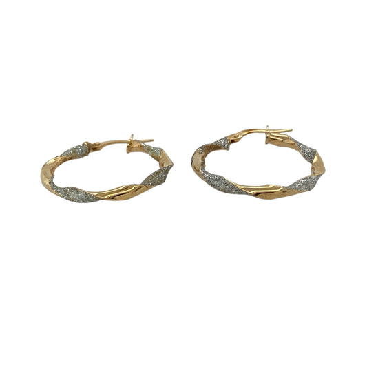 Bring elegant detail and timeless shine to your collection with these pre-owned 9ct yellow and white gold twisted sparkle hoop creole earrings, a versatile pair perfect for day-to-night wear.

Design: The earrings feature a hoop creole shape with a twisted two-tone design, combining yellow and white gold with a sparkling finish for added brilliance.
Material: Made from 9-carat yellow and white gold, the polished surfaces enhance the contrasting tones while giving the earrings a refined glow.