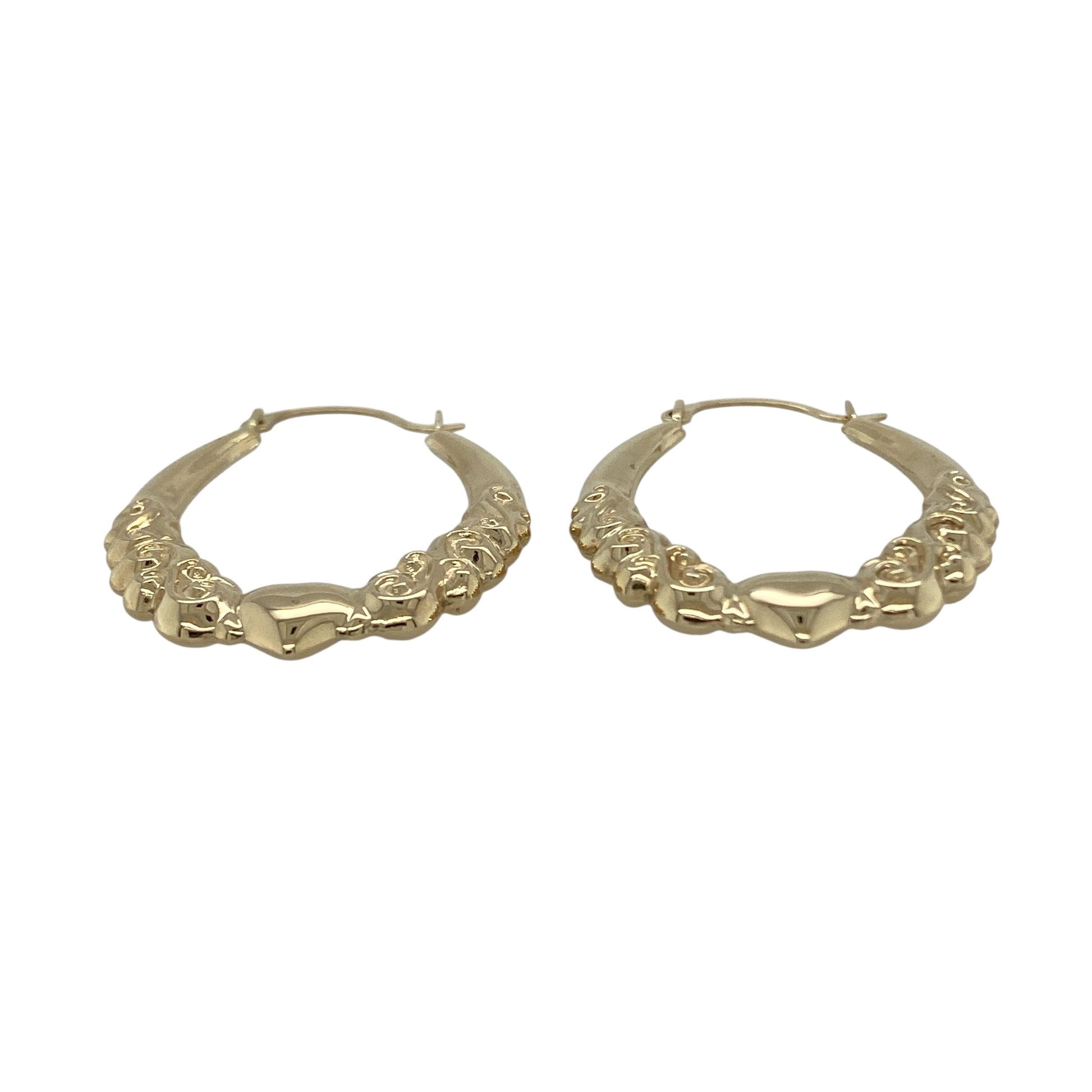 Bring romantic charm and classic style to your collection with these pre-owned 9ct yellow gold heart patterned oval creole earrings, a graceful design perfect for everyday wear or gifting.

Design: The earrings feature an oval creole shape decorated with a heart pattern, adding character and a touch of sentiment to a timeless style.
Material: Made from 9-carat yellow gold, the polished finish enhances the detailing while giving the earrings a warm glow.