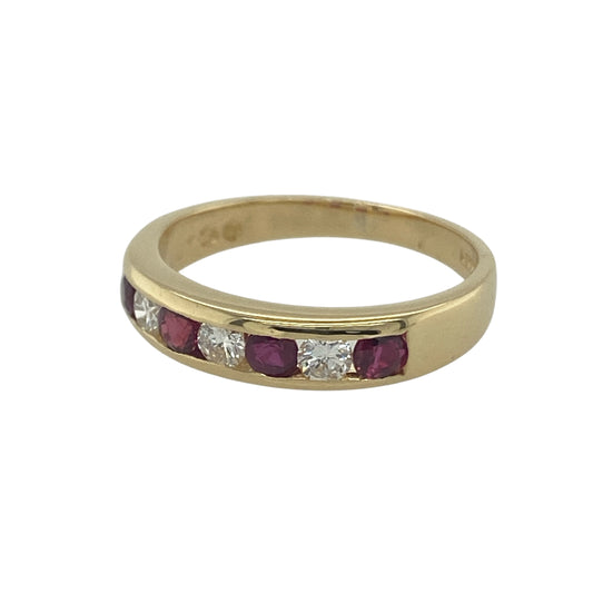 Bring vibrant colour and refined sparkle to your collection with this pre-owned 18ct yellow gold diamond and ruby band ring, a timeless design perfect for both everyday wear and special occasions.

Design: The ring features a 4mm wide band adorned with alternating 3mm round rubies and diamonds, creating a striking balance of colour and brilliance.
Material: Made from 18-carat yellow gold, the polished finish enhances the rich red of the rubies and the sparkle of the diamonds for a luxurious look.