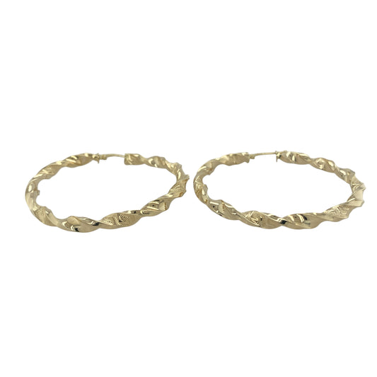 Bring bold detail and golden character to your collection with these pre-owned 9ct yellow gold twisted green key patterned large hoop creole earrings, combining classic form with intricate design.

Design: The earrings feature a large hoop creole shape with a twisted profile and a distinctive Greek key-style pattern, adding texture and unique appeal.
Material: Made from 9-carat yellow gold, the polished finish enhances the warm tone and highlights the intricate patterning.