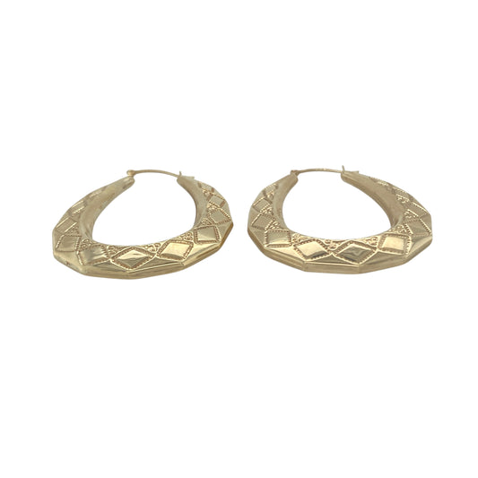 Bring bold style and golden detail to your collection with these pre-owned 9ct yellow gold large patterned oval creole earrings, a versatile design with timeless appeal.

Design: The earrings feature a large oval creole shape with intricate patterning, creating texture and elegant character.
Material: Made from 9-carat yellow gold, the polished finish enhances the warm tone and highlights the detailed design.