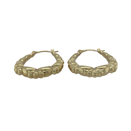Bring subtle texture and golden elegance to your collection with these pre-owned 9ct yellow gold oval patterned creole earrings, a versatile design with timeless charm.

Design: The earrings feature an oval creole shape with delicate patterning, adding refined detail and light-catching appeal.
Material: Made from 9-carat yellow gold, the polished finish enhances the warm tone and highlights the intricate design.