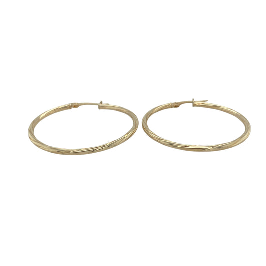 Bring classic elegance and golden shine to your collection with these pre-owned 9ct yellow gold twisted hoop creole earrings, a timeless style with subtle detail.

Design: The earrings feature a traditional hoop creole shape with a gentle twisted pattern, adding texture and light-catching appeal.
Material: Made from 9-carat yellow gold, the polished finish enhances the warm tone and highlights the twist design.