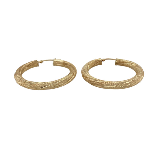 Bring golden shine and textured detail to your collection with these pre-owned 9ct yellow gold textured twisted hoop creole earrings, a timeless design with added character.

Design: The earrings feature a traditional hoop creole shape with a twisted profile and textured finish, creating movement and light-catching appeal.
Material: Made from 9-carat yellow gold, the polished surface enhances the warm tone and highlights the detailed twist design.