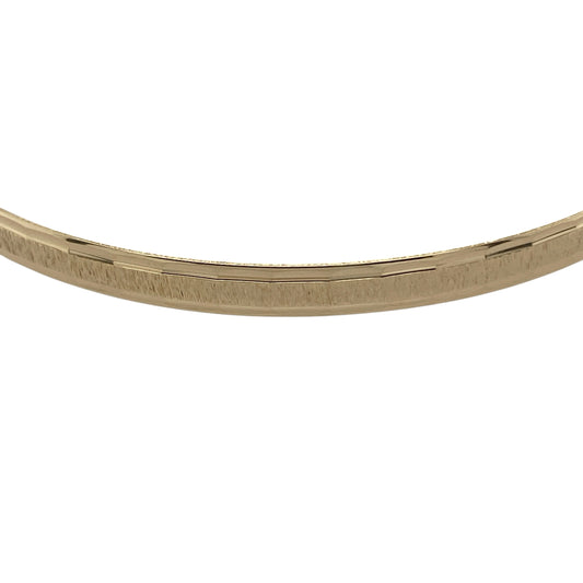 Bring timeless sophistication and golden detail to your collection with this pre-owned 9ct yellow gold solid patterned bangle, a classic piece that balances durability with refined elegance.

Design: The bangle showcases a solid form with a patterned finish, offering strength alongside decorative charm for everyday wear or special occasions.
Material: Made from 9-carat yellow gold, the polished surface enhances the pattern and radiates a warm, lasting glow.