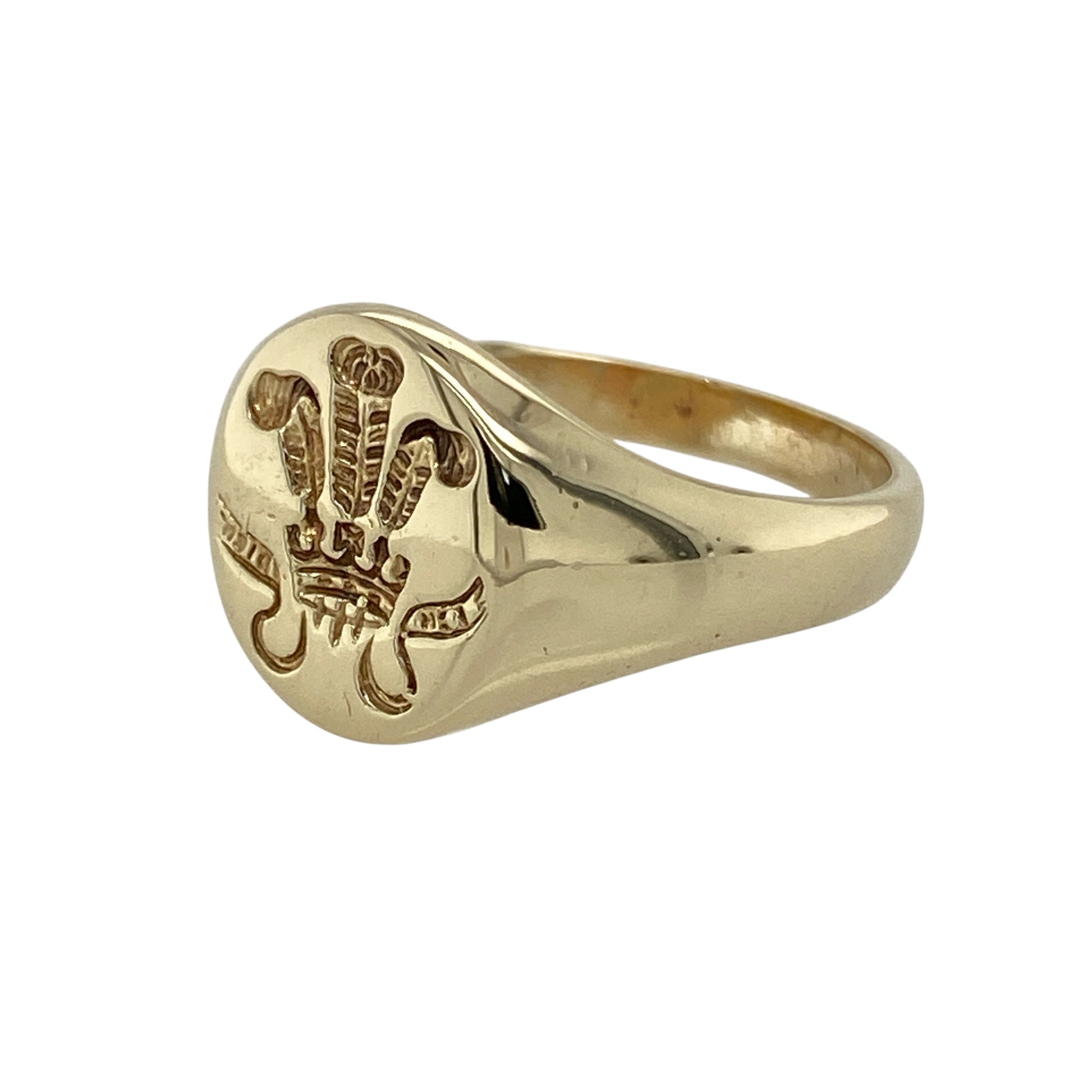 Bring bold detail and traditional style to your collection with this pre-owned 9ct yellow gold three feathers oval signet ring, a distinctive design with symbolic character.

Design: The ring features a 13mm high oval front engraved with a three feathers motif, adding heritage-inspired detail to a classic signet profile.
Material: Made from 9-carat yellow gold, the polished finish enhances the engraving while giving the piece a warm and refined glow.