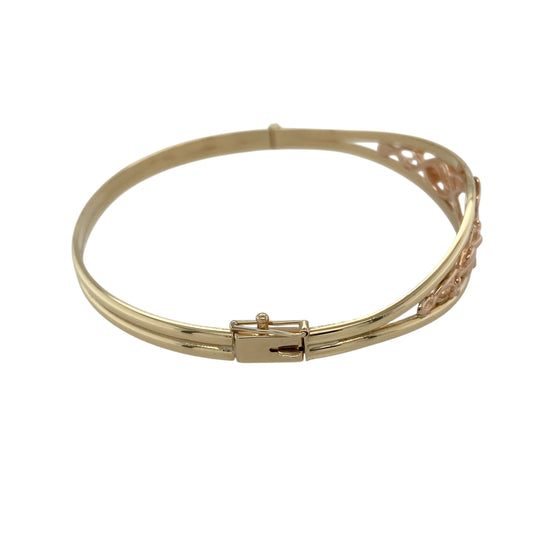 Bring symbolic elegance and timeless style to your collection with this pre-owned 9ct yellow and rose gold Clogau Tree of Life bangle, a meaningful design representing growth, strength, and continuity.

Design: The bangle features the iconic Tree of Life motif across the 12mm high front, blending yellow and rose gold for a distinctive two-tone finish.
Material: Made from 9-carat yellow and rose gold, the polished surface enhances the intricate detailing and rich golden tones.