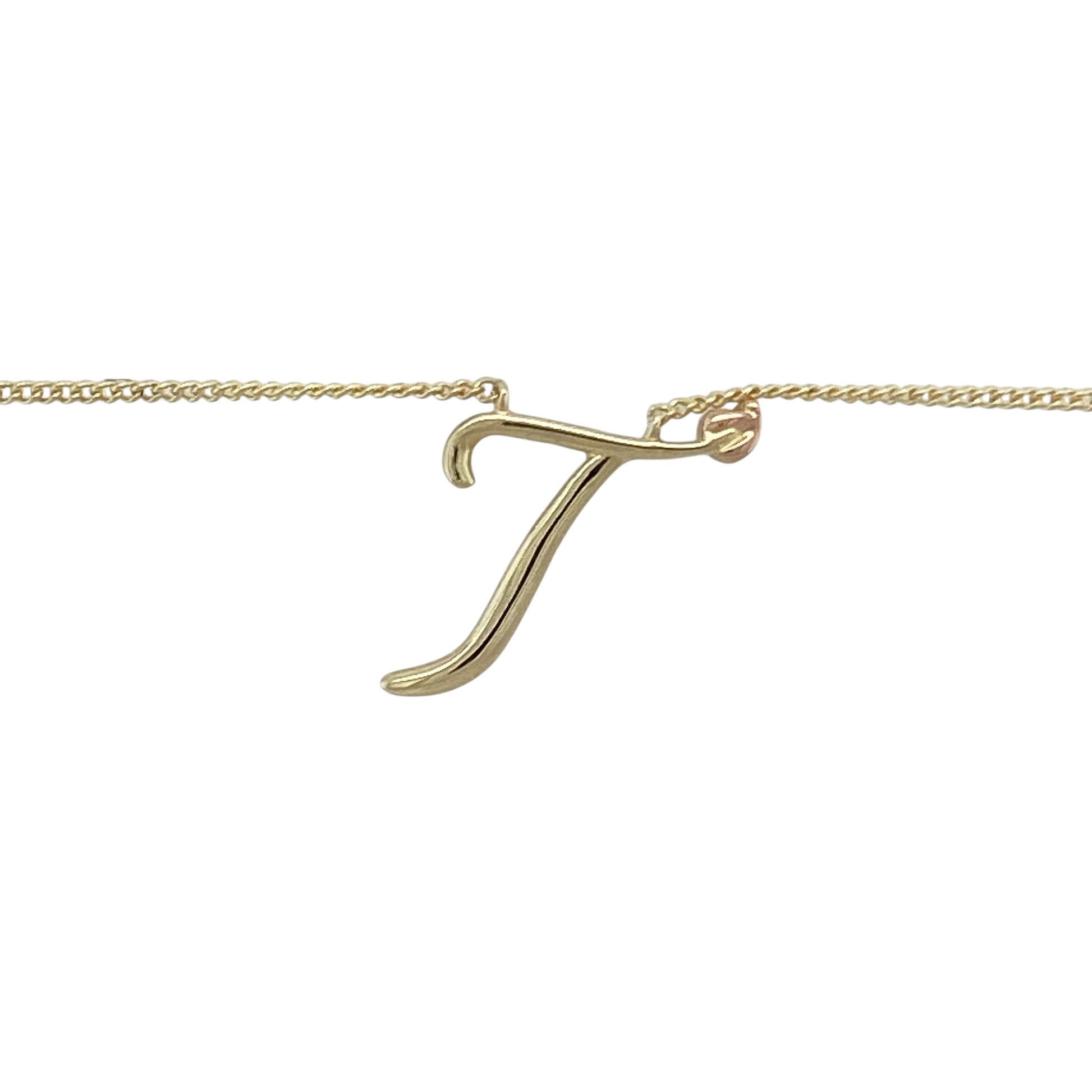 Bring personal meaning and elegant detail to your collection with this pre-owned 9ct yellow and rose gold Clogau Tree of Life initial ‘T’ necklace, a symbolic piece blending heritage design with timeless style.

Design: The necklace features a 1.5cm long initial ‘T’ pendant adorned with the iconic Tree of Life motif, combining yellow and rose gold for a distinctive two-tone finish.
Material: Made from 9-carat yellow and rose gold, the polished surface highlights the intricate detailing and warm tones.