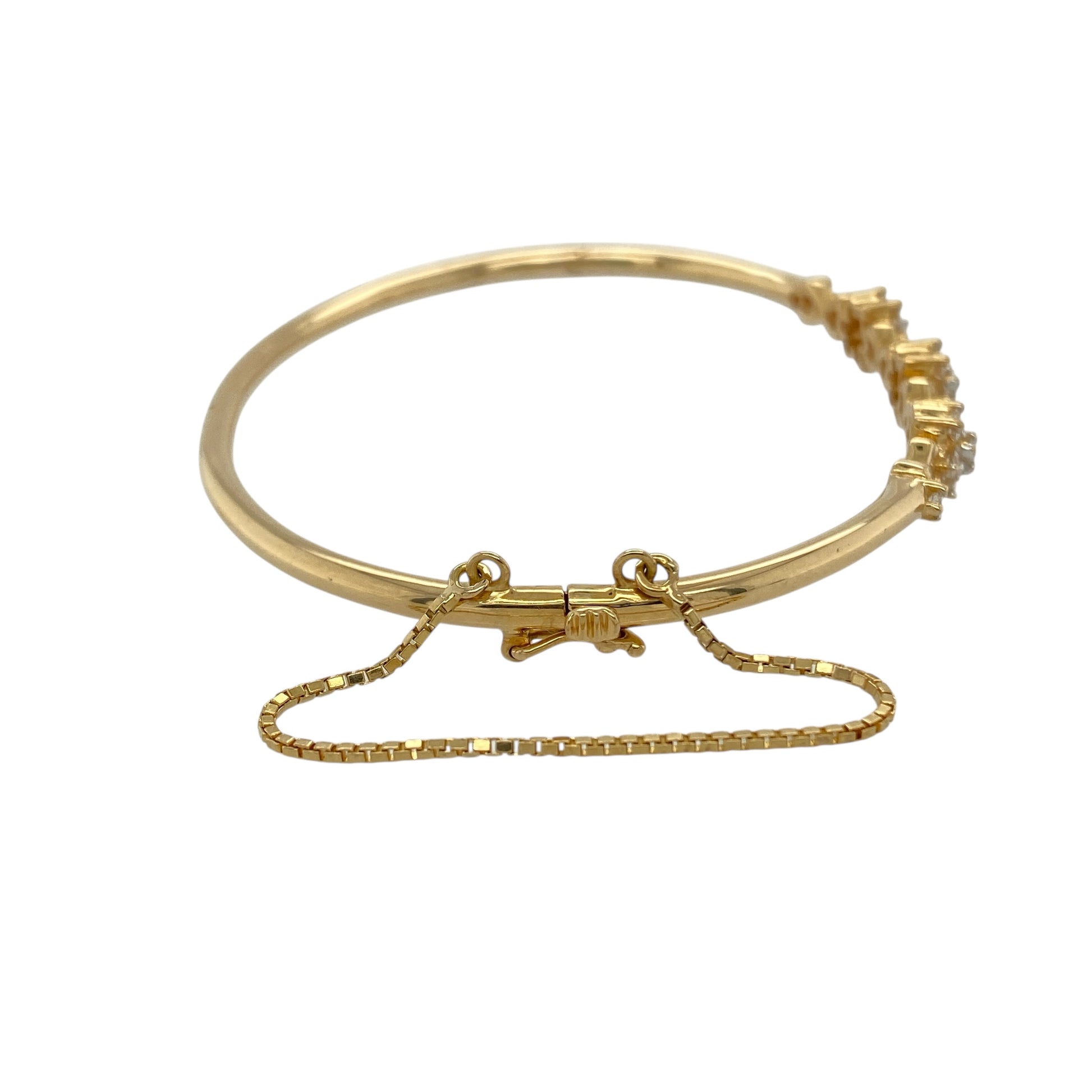 Bring timeless sparkle and floral elegance to your collection with this pre-owned 18ct yellow gold diamond flower cluster bangle—a refined piece combining beauty and sophistication.

Design: The bangle features a central flower cluster motif adorned with diamonds, adding brilliance and a touch of vintage-inspired charm. A fitted safety chain provides extra security while wearing.
Material: Made from 18-carat yellow gold, the polished finish enhances the warmth of the gold and the sparkle of the diamonds.