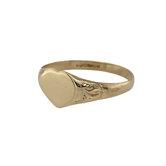 Bring delicate charm and subtle detail to your collection with this pre-owned 9ct yellow gold heart signet ring—a graceful piece with a feminine touch.

Design: The ring features a 7mm high heart-shaped front, complemented by patterned shoulders that add extra character and style.
Material: Made from 9-carat yellow gold, the polished finish enhances both the engraved details and the warm golden tones.