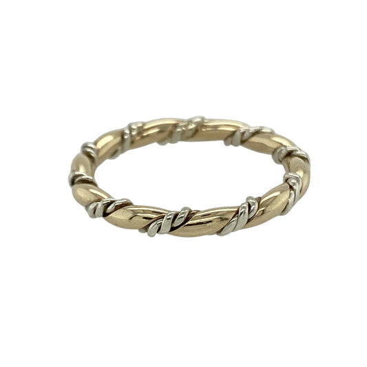 Bring subtle elegance and modern style to your collection with this pre-owned 9ct yellow and white gold twisted band ring—a versatile piece with a timeless two-tone design.

Design: The ring features a 2mm wide band with a twisted pattern that interweaves yellow and white gold for a refined and contemporary finish.
Material: Made from 9-carat yellow and white gold, the polished surfaces enhance the soft contrast between the two metals.