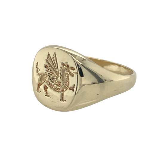 Bring heritage pride and classic style to your collection with this pre-owned 9ct yellow gold Welsh Dragon signet ring—a bold design symbolising strength and tradition.

Design: The ring features a 13mm high round front engraved with the iconic Welsh Dragon, representing courage, power, and national pride.
Material: Made from 9-carat yellow gold, the polished finish enhances the engraved detail and rich golden tones.