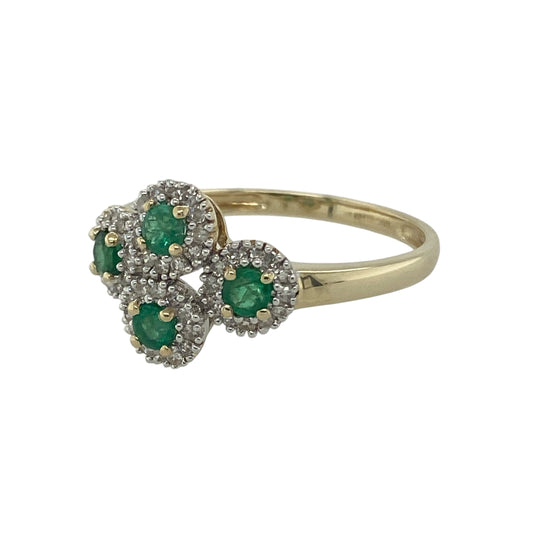 Bring vibrant colour and elegant sparkle to your collection with this pre-owned 9ct yellow gold emerald and diamond cluster ring—a timeless design with refined detail.

Design: The ring features four clusters, each centred with a 3mm round emerald surrounded by a halo of small diamonds, creating brilliance and contrast.
Material: Made from 9-carat yellow gold with emerald and diamond accents, the polished finish enhances the rich green tones of the emeralds and the sparkle of the diamonds.