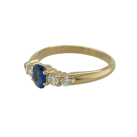 Bring refined elegance and timeless beauty to your jewellery collection with this pre-owned 18ct yellow gold diamond and sapphire ring, combining rich colour with sparkling detail—perfect for celebrating special occasions or adding everyday luxury.

Design: The ring highlights a 6mm by 4mm oval-cut sapphire at the centre, framed by two round brilliant-cut diamonds on either side, offering a balanced and graceful look.