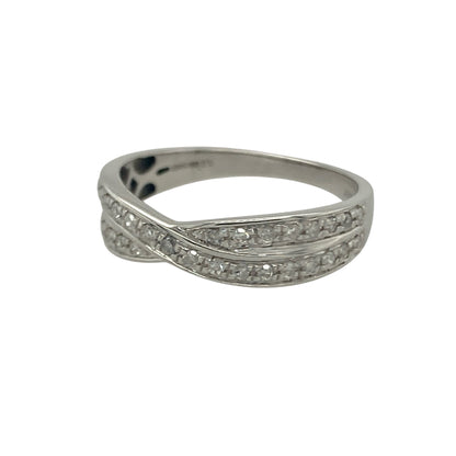 Bring modern elegance and sparkling detail to your collection with this pre-owned 18ct white gold diamond crossover band ring, a stylish design that balances sophistication with everyday wearability.

Design: The ring features an elegant crossover style band, set with approximately 0.25ct of brilliant-cut diamonds that add radiant sparkle across the design.
Material: Made from 18-carat white gold, the polished finish enhances the brilliance of the diamonds while offering a sleek, contemporary look.