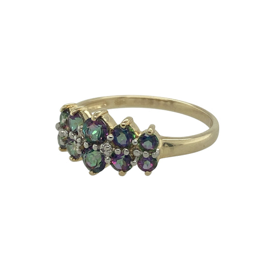 Bring vibrant colour and bold style to your collection with this pre-owned 9ct yellow gold mystic topaz two row band ring, a striking piece full of sparkle and character.

Design: The ring features an 8mm wide front styled with two rows of mystic topaz stones, displaying iridescent flashes of colour for a unique and eye-catching look.
Material: Made from 9-carat yellow gold, the polished finish enhances the vivid tones of the mystic topaz and adds warmth to the overall design.