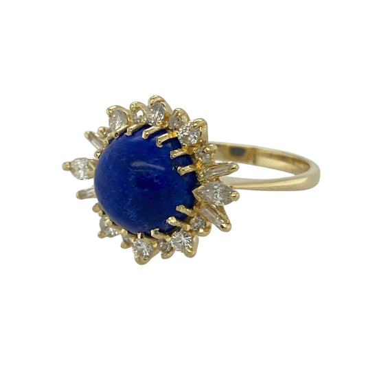 Bring striking colour and elegant sparkle to your collection with this pre-owned 18ct yellow gold diamond and lapis lazuli cluster ring, a bold and eye-catching design.

Design: The ring features a 10mm round lapis lazuli stone at the centre, surrounded by a cluster of brilliant, marquise, and baguette-cut diamonds for a unique and radiant finish.
Material: Made from 18-carat yellow gold, the polished finish enhances the rich blue tones of the lapis and the brilliance of the diamonds.