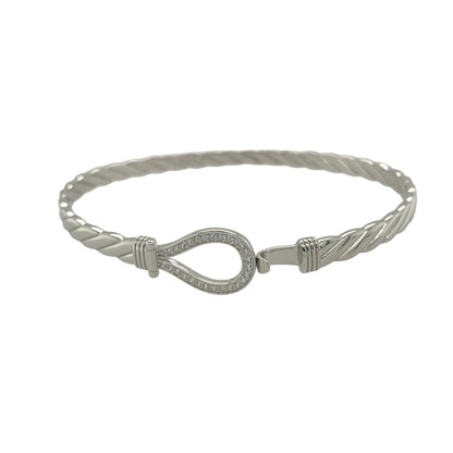 Bring refined sparkle and timeless charm to your collection with this new 925 silver cubic zirconia horseshoe bangle, a beautifully symbolic design representing luck and positivity.

Design: The bangle features a 12mm high front with a classic horseshoe motif, adorned with sparkling cubic zirconia stones for a radiant and elegant finish.
Material: Made from solid 925 sterling silver, the polished surface enhances the brilliance of the stones and gives the piece a sleek, sophisticated appearance.